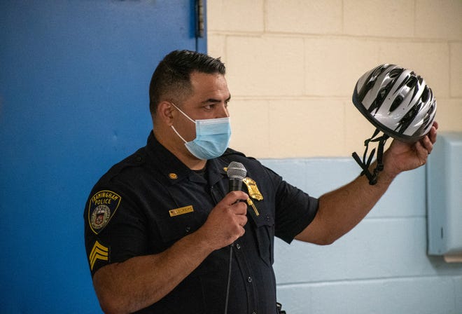 Officer holding bicycle helmet