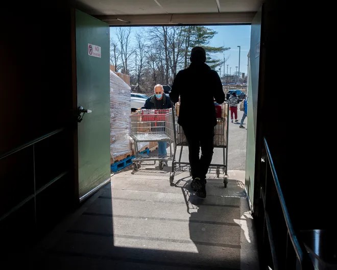 Volunteers bring groceries out to clients cars