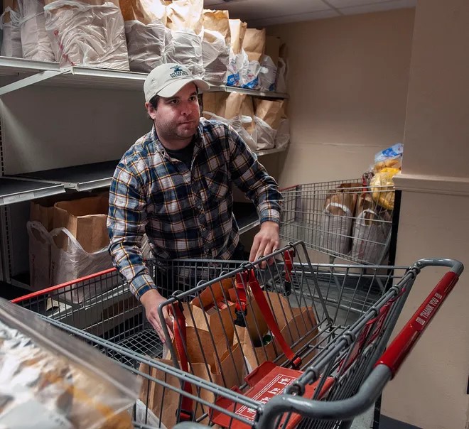 Volunteer Matt Neal prepares groceries at Pearl Street Cupboard