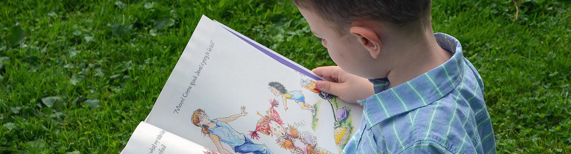 Young boy reads children's book