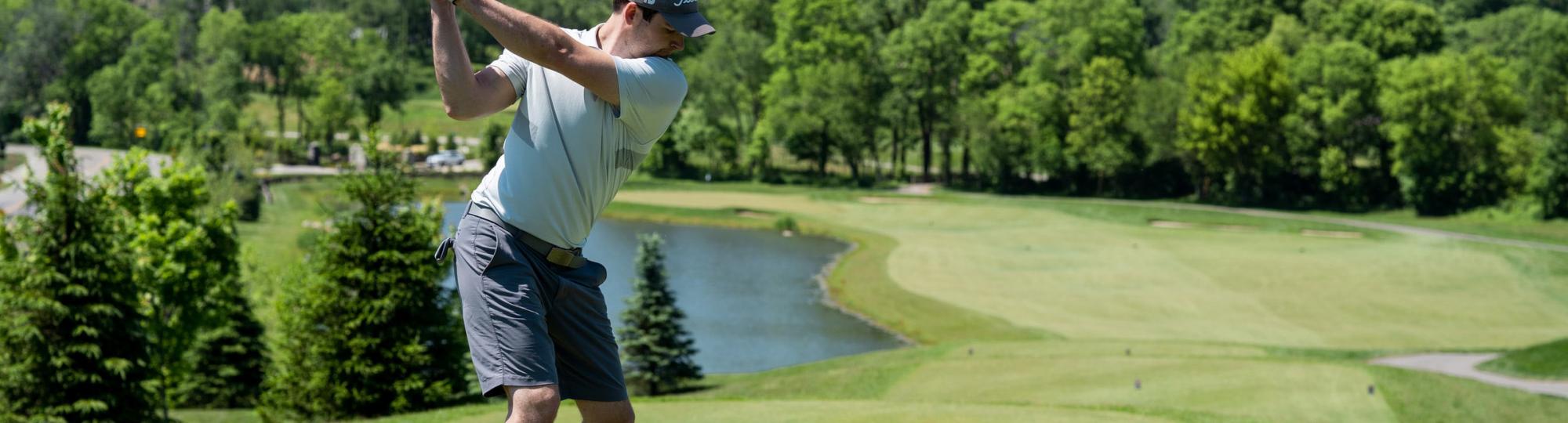 Golfer teeing off