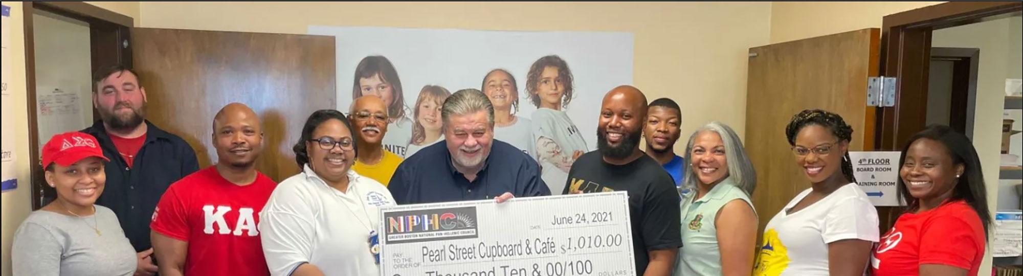 Greater Boston Pan-Hellenic Council presents check to Pearl St. Cupboard & Café
